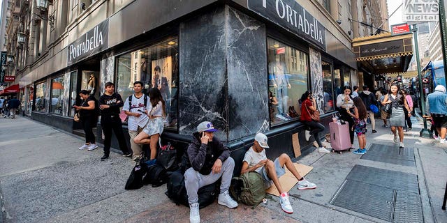 Migrants sitting on Manhattan street corner