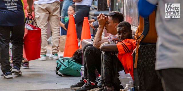 Migrants sitting outside Roosevelt Hotel