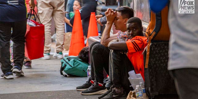 Migrants sitting outside Roosevelt Hotel