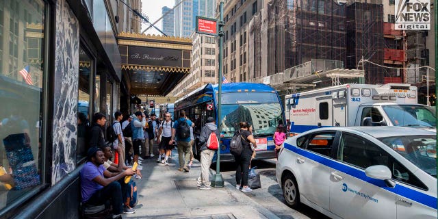 Migrants arrive at the Roosevelt Hotel in Manhattan