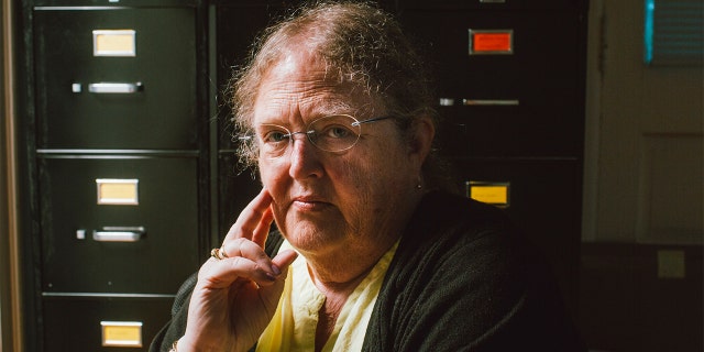 Rep. Reckitt staring into the camera holding her hand in pose on her face.