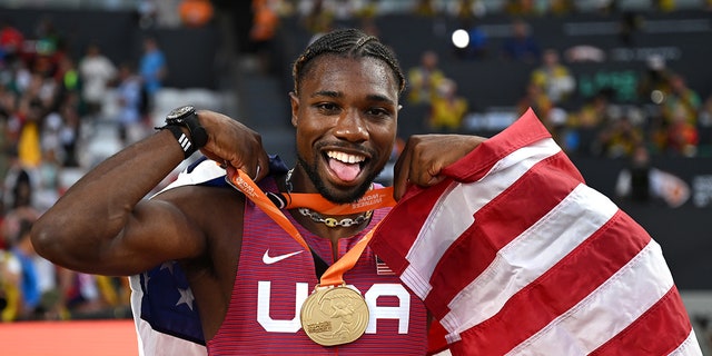 Noah Lyles poses with the gold medal