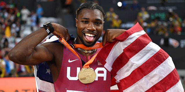 Noah Lyles poses with gold medal