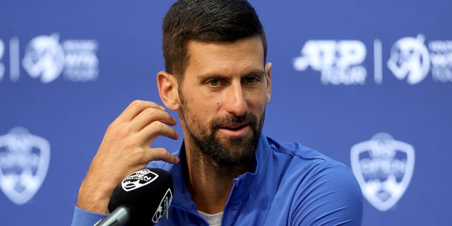 Novak Djokovic talks to reporters