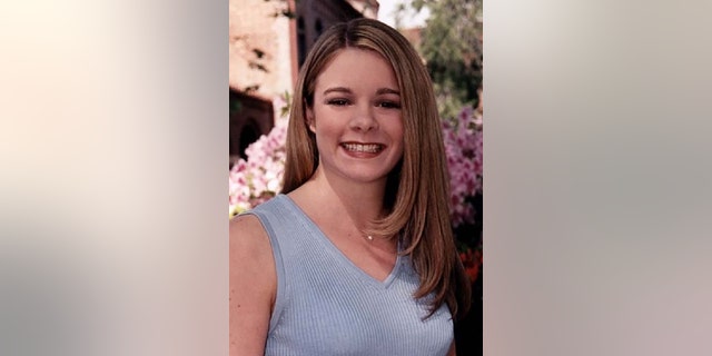 Christie Wilson smiling and wearing a blue sleeveless top