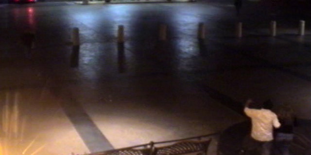 A screengrab of a parking lot with Mario Garcia wearing a white shirt