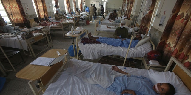 Injured people lie on hospital beds