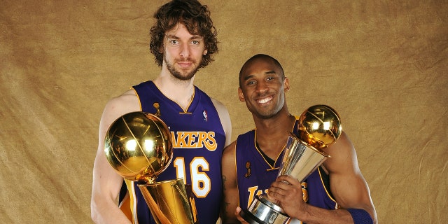 Pau Gasol and Kobe Bryant pose with trophies