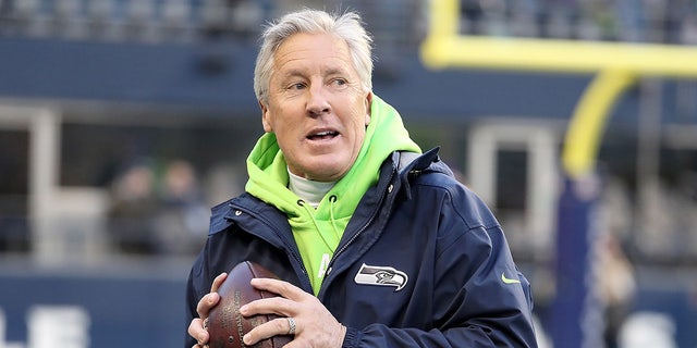Pete Carroll of the Seattle Seahawks throws the ball