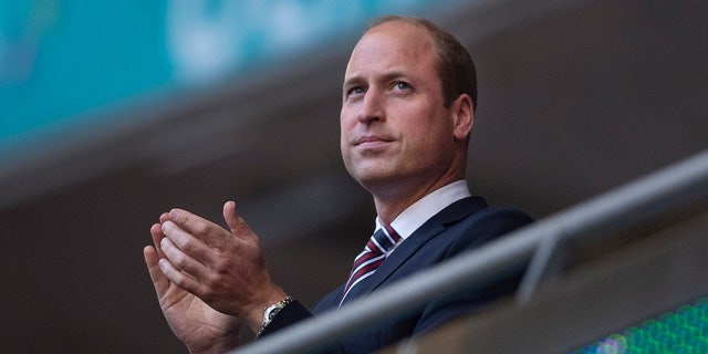 Prince William applauds during a soccer match