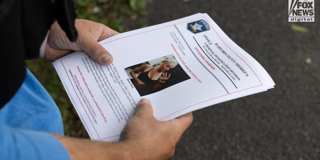A closeup of hands holding flyers