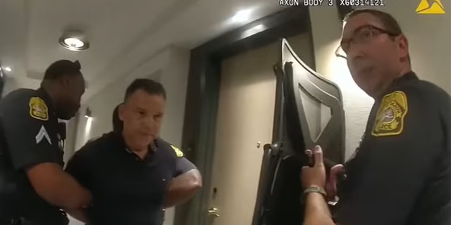 Alfredo Ramirez show with his hands behind his back being handcuffed.