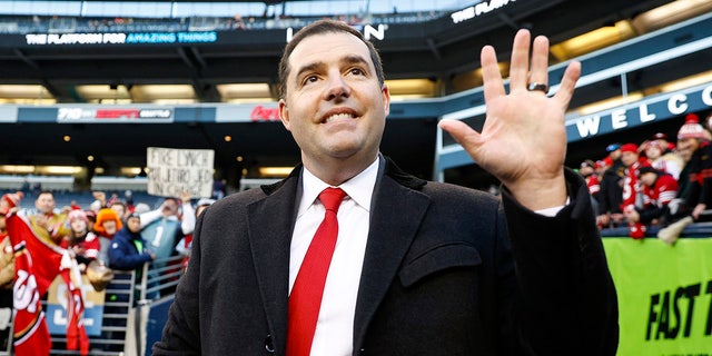 Jed York stands on the football field
