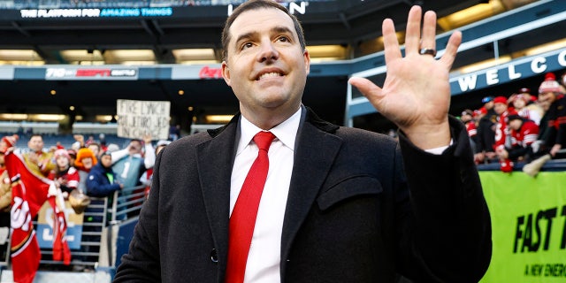 Jed York stands on the football field