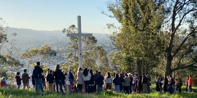 photo of Christians gathered at cross at Albany Hill Park