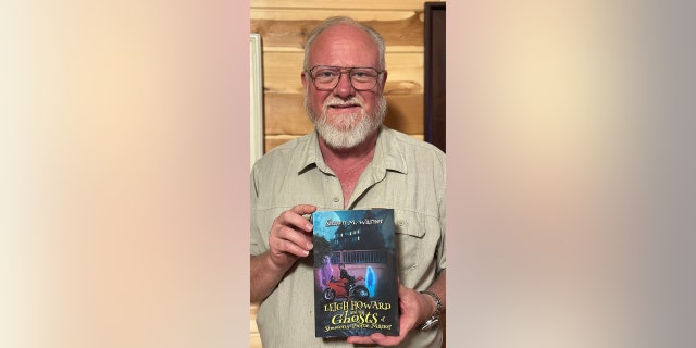 Shawn Warner holding book