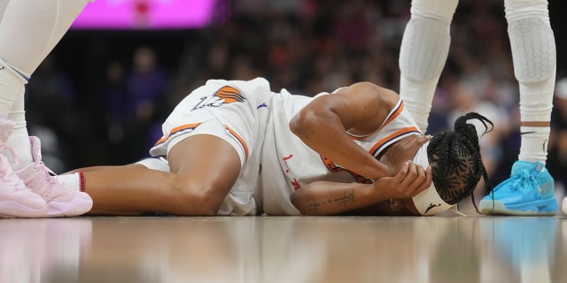 Shey Peddy on the floor in pain