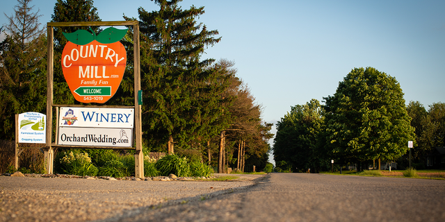 Country Mill Farm sign seen looking up from road