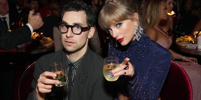 Jack Antonoff and Taylor Swift toast at the Grammys