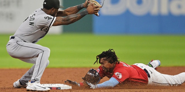 Jose Ramirez slides into Tim Anderson