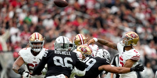 Trey Lance throws a pass