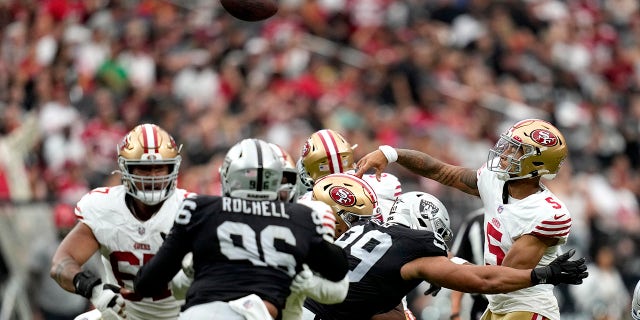 Trey Lance throws a pass