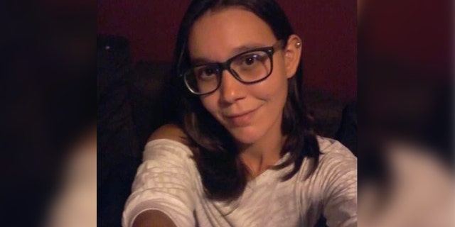 Trish Haynes in selfie with dark hair, glasses, and white shirt
