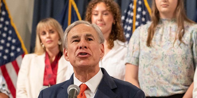 Abbott at a bill signing