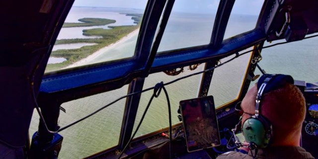 Coast Guard aircraft searching waters
