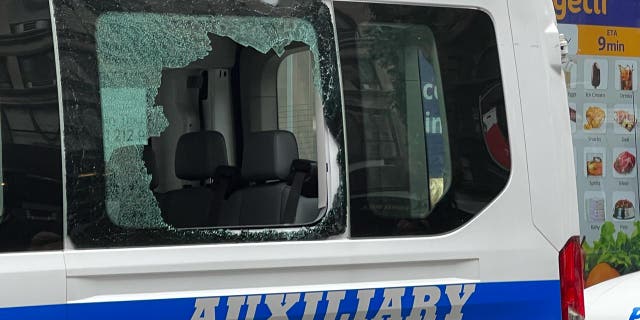 A white NYPD van with broken windows