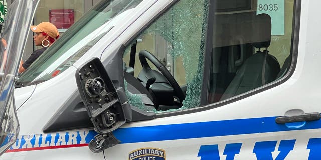 A white NYPD van with broken windows