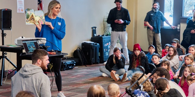 Riley Gaines reads book to children