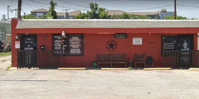 Red-walled tattoo shop on side of Texas road in Arlington where a shooting took place Tuesday