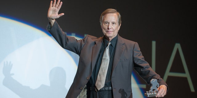 William Friedkin on stage accepting an award