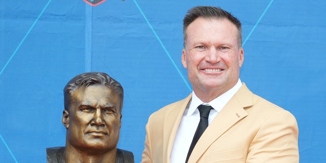 Zach Thomas smiles with bust