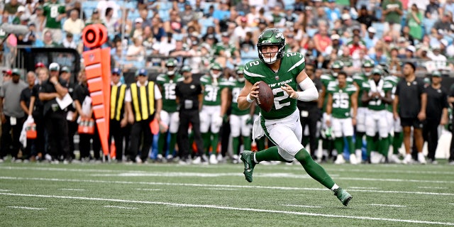 Zach Wilson rolls out during a Jets preseason game