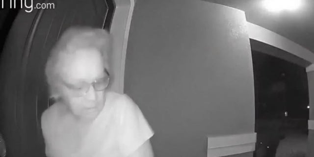 Gina Helsel going back inside her door as she sees a bear