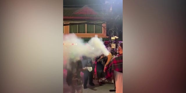 Tourist in Thailand blows smoke