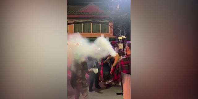 Tourist in Thailand blows smoke