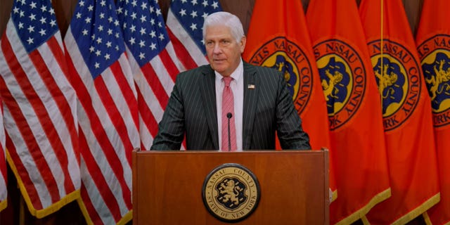Bruce Blakeman stands in front of podium