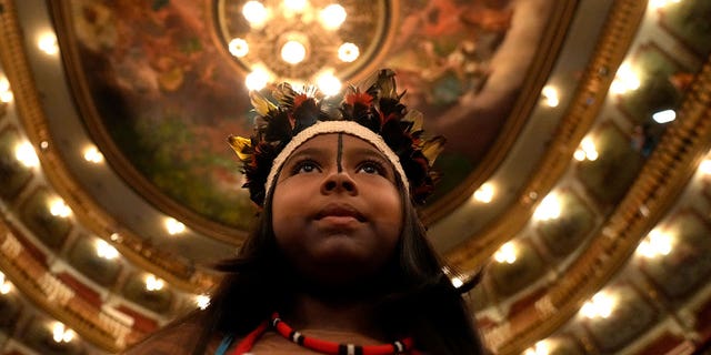 child stands at Brazilian theater