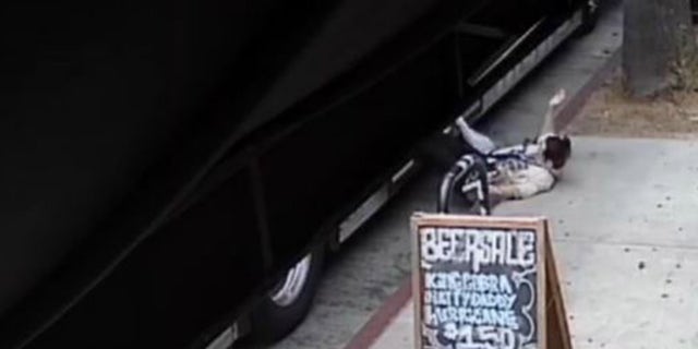 surveillance footage of woman falling off bus