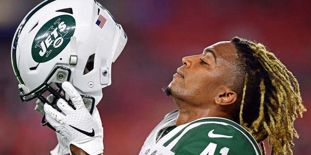 Buster Skrine putting helmet on