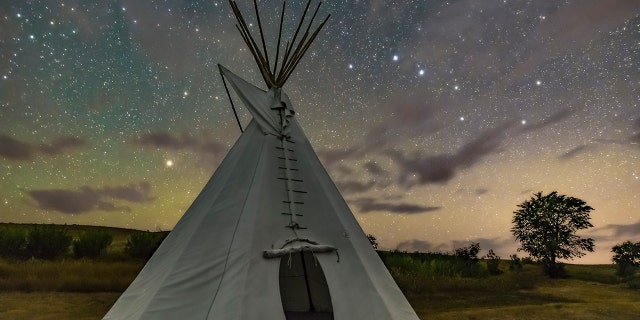 A tent set up under a starry sky