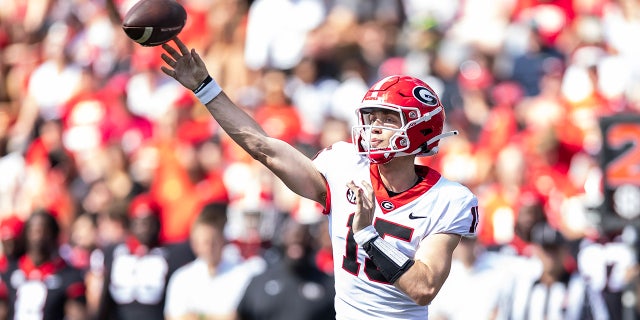 Carson Beck throwing