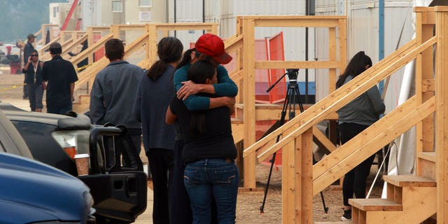 people hugging at shelter