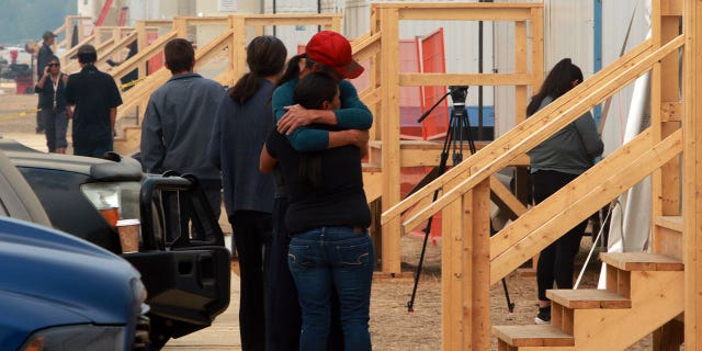 people hugging at shelter