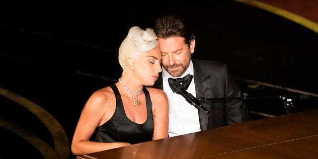Bradley Cooper playing the piano with Lady Gaga