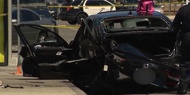 Smashed black Honda sedan