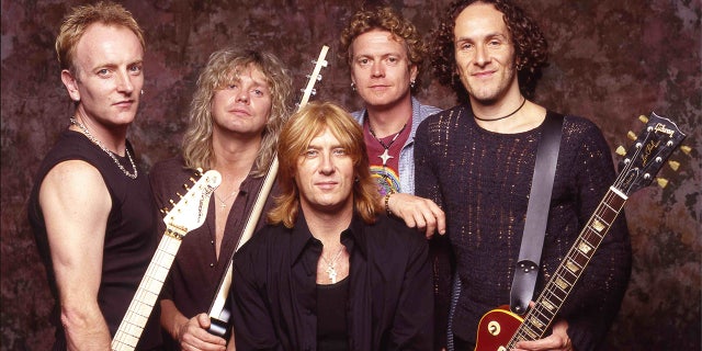 Old picture of Def Leppard Phil Cohen, Rick Savage, Joe Elliot center, Rick Allen and Vivian Campbelll